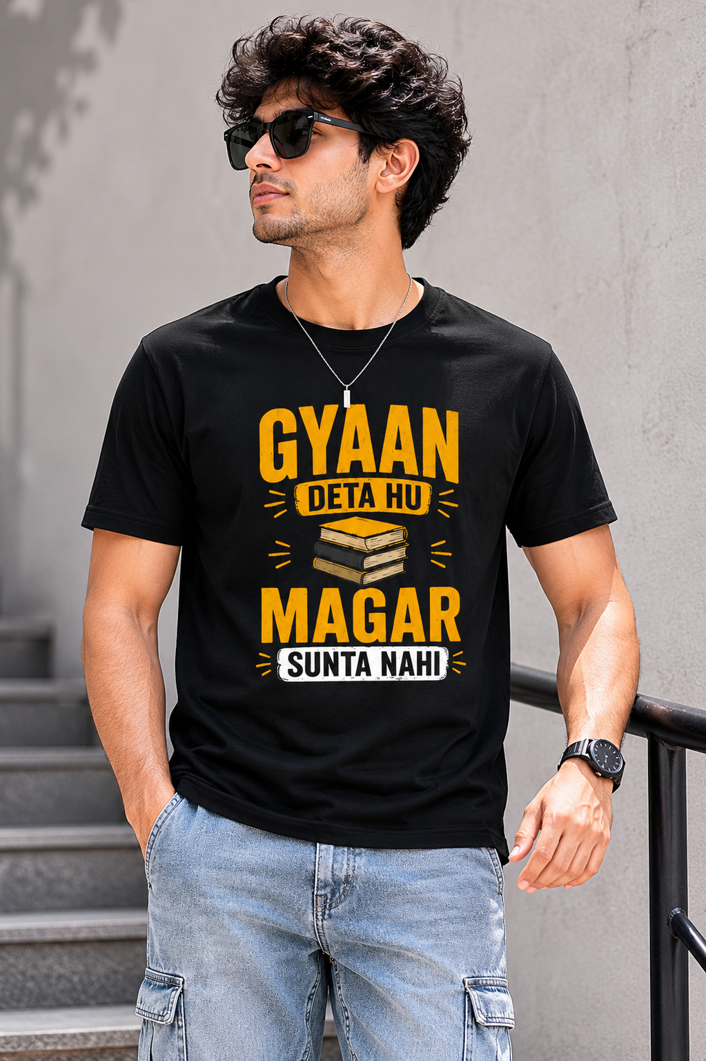 Man wearing a black t-shirt with yellow text against a gray background