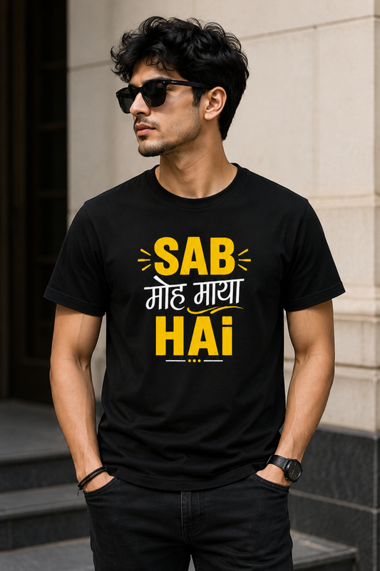 Man wearing a black t-shirt with yellow and white text standing outdoors.
